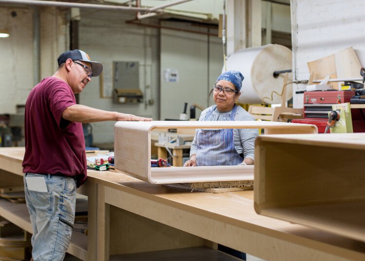 Workers create furniture at The Worden Company.