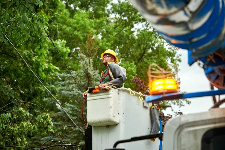 A Consumers Energy lineworker works from a bucket to restore power in Grand Rapids after a storm in 2019. (Consumers Energy)