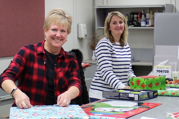 Trendway employees wrap Christmas gifts that will be given to foster children.