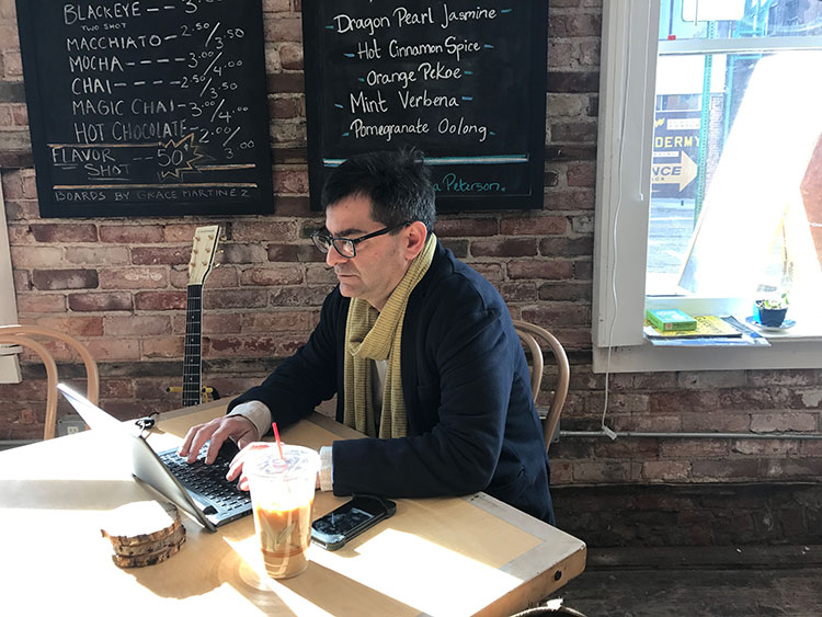 Attorney Eric Dobrusin working at the Alleycat Cafe. Photo by Nina Ignaczak.