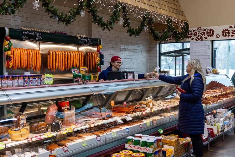 A customer orders from the meat deptartment at Srodek's.