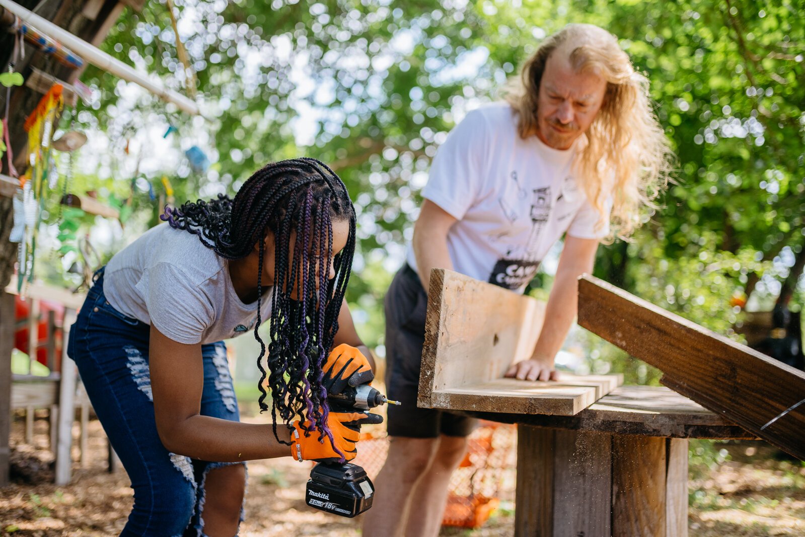 A Camp Carpenter participant works on a project with a counselor at Carpenter Park in Detroit.