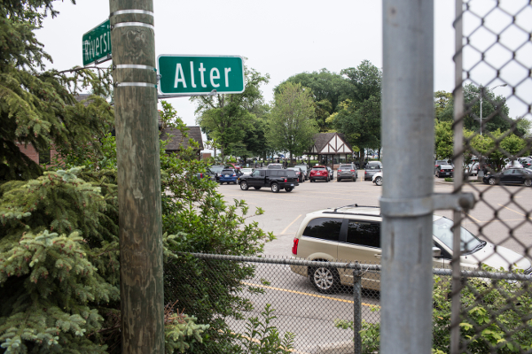 Standing in Detroit, peering across chain-link fence into Grosse Pointe Park's members-only municipal park from Alter Road.