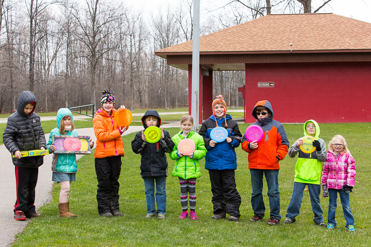 Kids posing with their frisbees