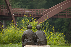 A sculpture  looks toward the Tridge in Midland, MI