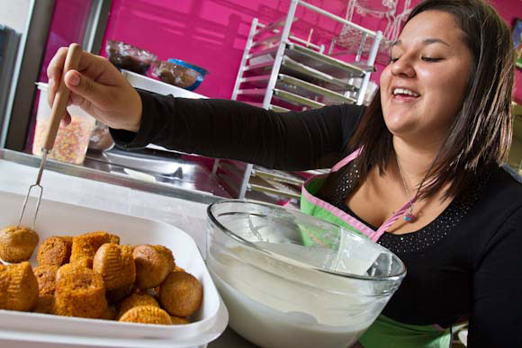 Nicole Wingert dipping cupcakes at the Gourmet Cupcake Shoppe--a wonderful Midland business. 