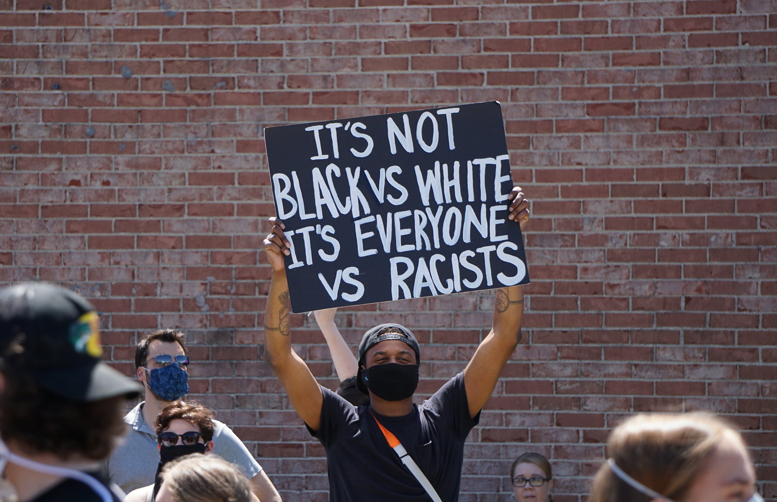 A man holds a sign at the protest in Midland on June 7.