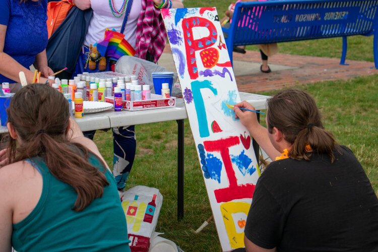 Festival goers paint Pride signs