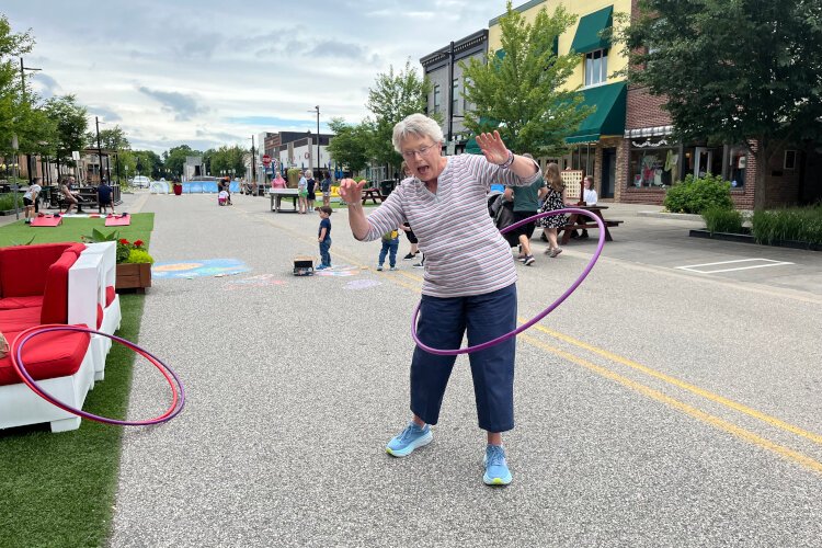 Atendees enjoying hula hoop downtown at Adult Recess