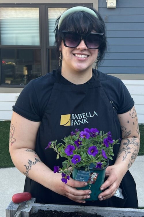 Katie Blanchard from Isabella Bank volunteers to help plant flowers at the Memory Garden