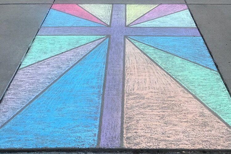 A stained-glass style chalk design on a cross in Midland.