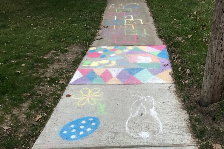 A hopscotch game, bunnies, eggs and colorful patterns greet walkers in Midland.