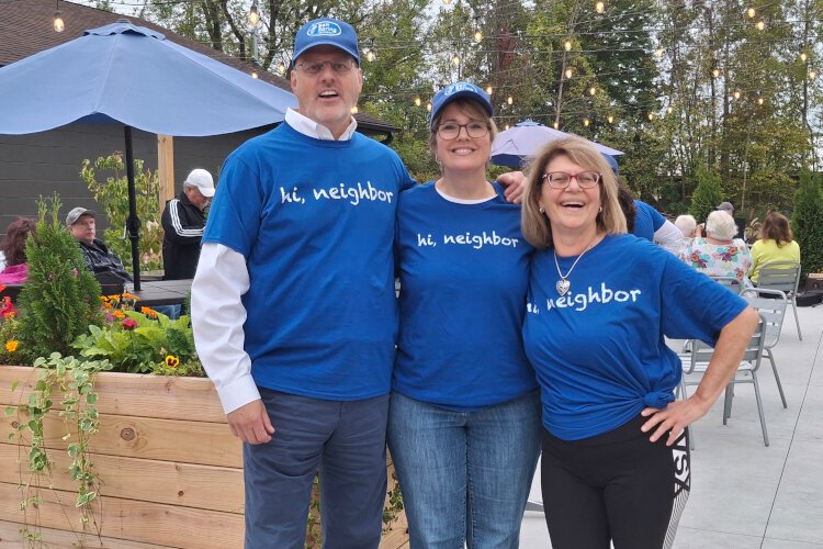 Joe and Bridgit Sova with Delores Porte show off "Hi Neighbor" shirts.