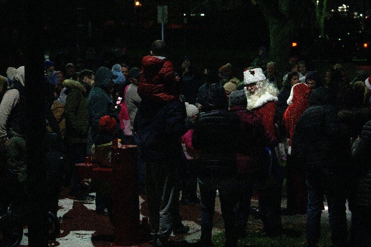 Santa was greeted by enthusiastic children and adults alike. The crowd then sang, “Santa’s Coming to Town.”