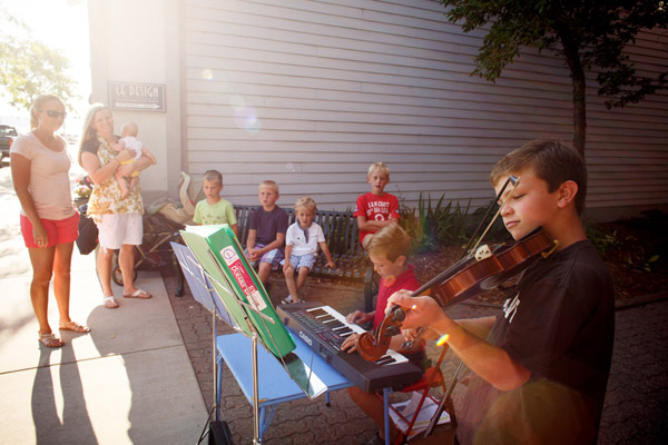 Two young, local musicians entertain at Stroll the Streets.