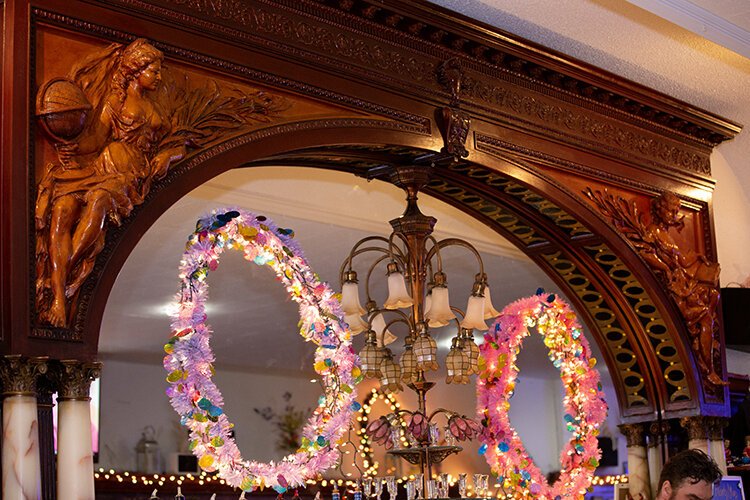 Behind the bar are a few features original to the establishment such as the Tiffany lights and mahogany wood centerpiece depicting the goddess of wisdom (right) and the goddess of knowledge.