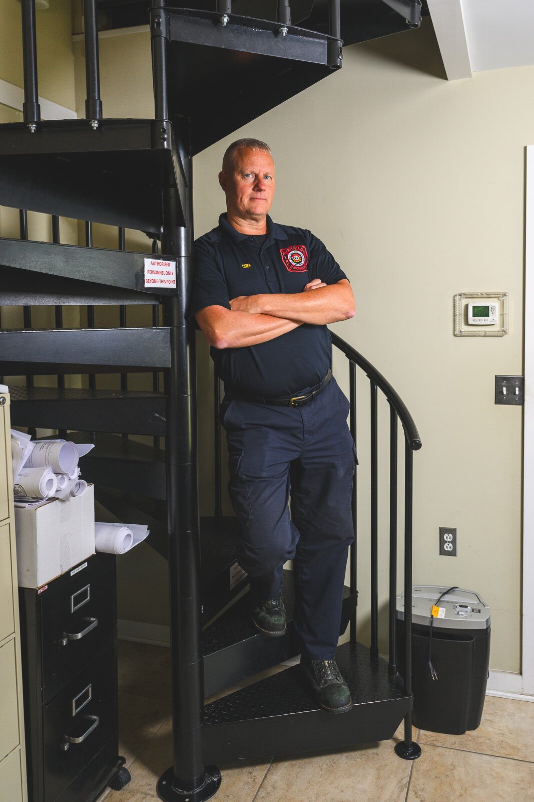 Chief Robert Arbini by the spiral staircase to the fire station office.