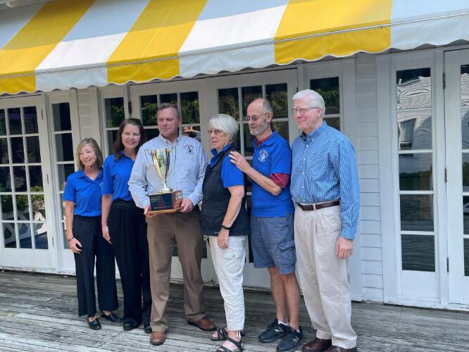 Houghton city officials and beautification committee members pose with the trophy from the Michigan Municipal League.