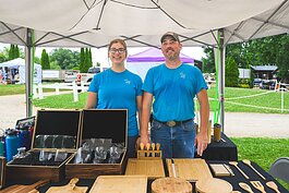 Annalies Walsh and her father Joe Walsh selling Manchester Entrepreneurial STEM merchandise at Waterloo Hunt Club in Grass Lake.
