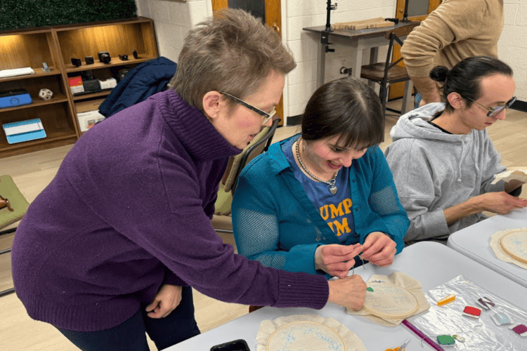 Lori Weatherly (left) teaches an embroidery class at the Make Saint Clair makerspace.