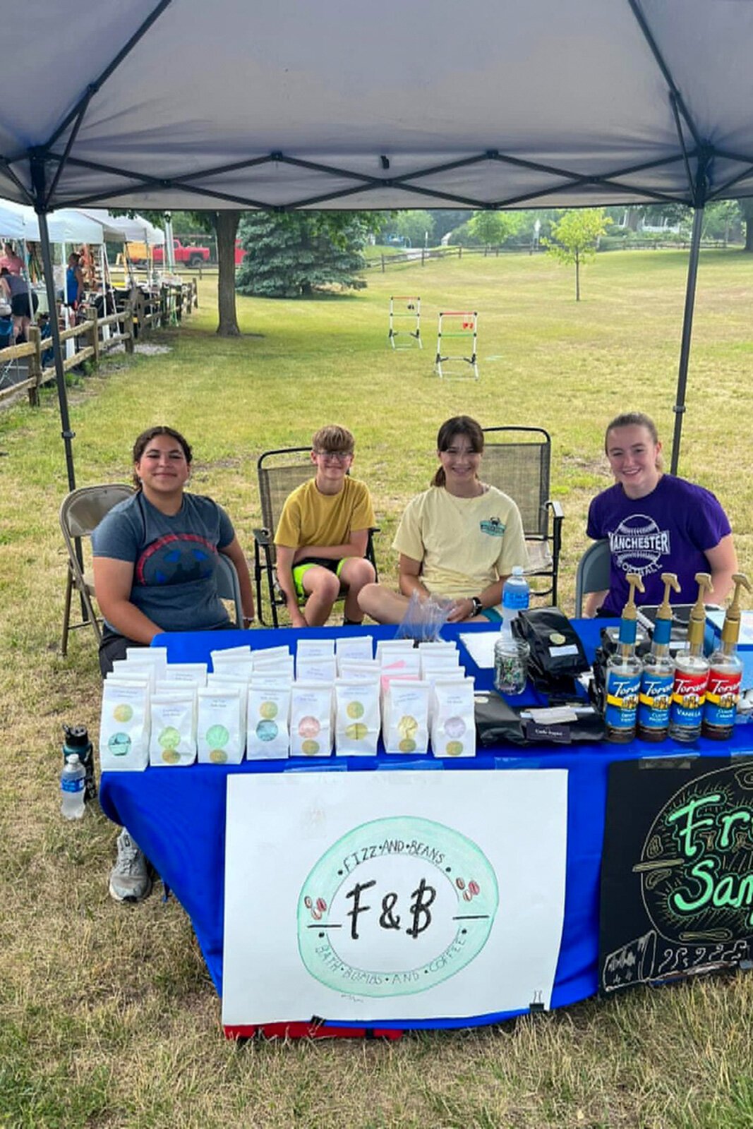 Manchester Entrepreneurial STEM students selling merchandise.