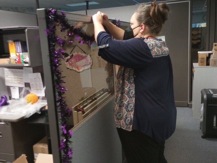 Meresa Salisbury decorates her office at Disability Network West Michigan. 