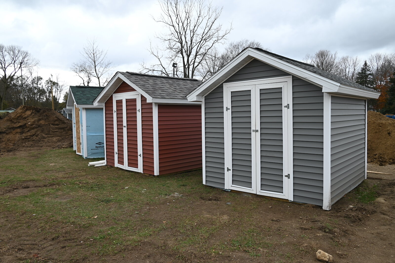 Outdoor storage sheds which will belong to three houses currently under construction near LaMora Park Elementary.