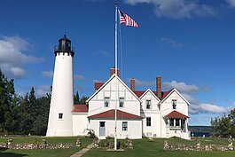 A newly renovated Point Iroquois Lighthouse gleams at Hiawatha National Forest.