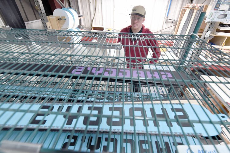 Avid ski and company co-founder Jeff Thompson inspects custom-made skis.