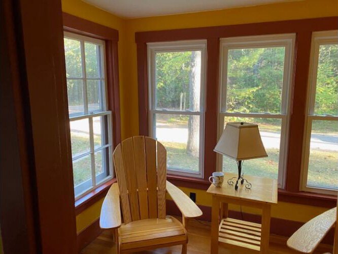 An enclosed sunporch is furnished with Adirondack chairs built by inmates in the Michigan Prison Build program at the Thumb Correctional Facility in Lapeer.