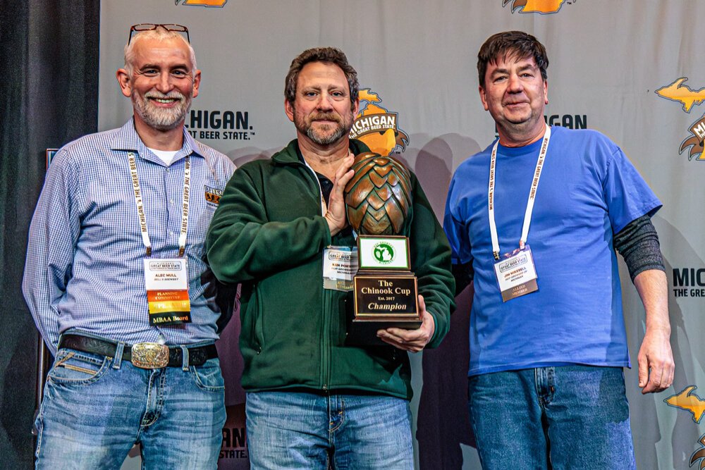 2025 Chinook Cup Winner: Dog Star Hops. Pictured (l-r) Alec Mull, Bell’s Brewery, presents the award to Ken Porter and Jim Mikesell of Dog Star Hops, Charlotte.