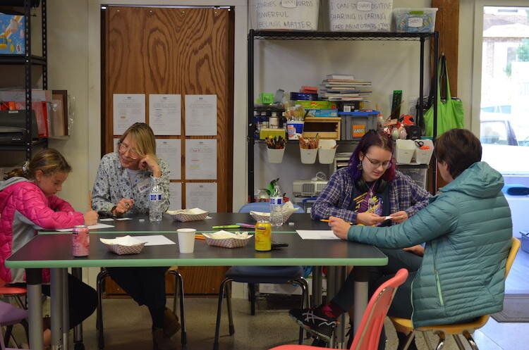 The group splits into pairs to brainstorm business ideas as a part of an exercise at the event. 