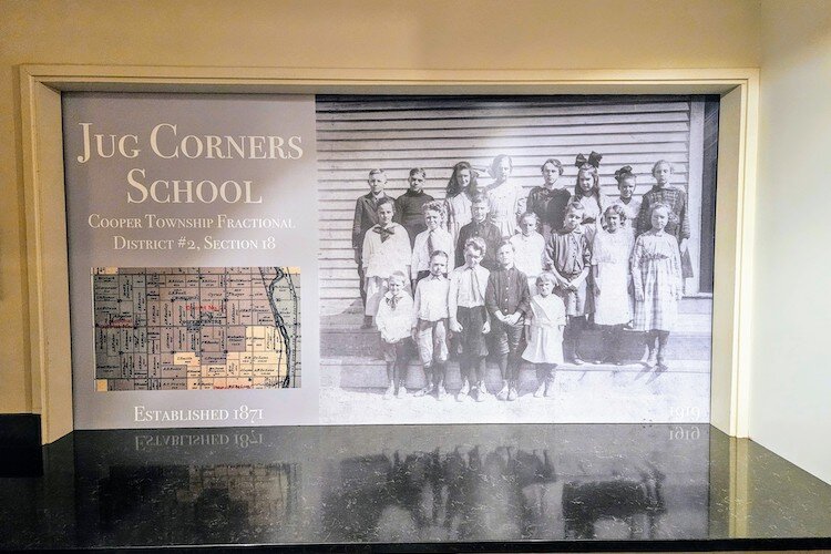 In the Bellfower kitchen, a sliding door features the Jug School's last class on one side and a chalkboard on the other.