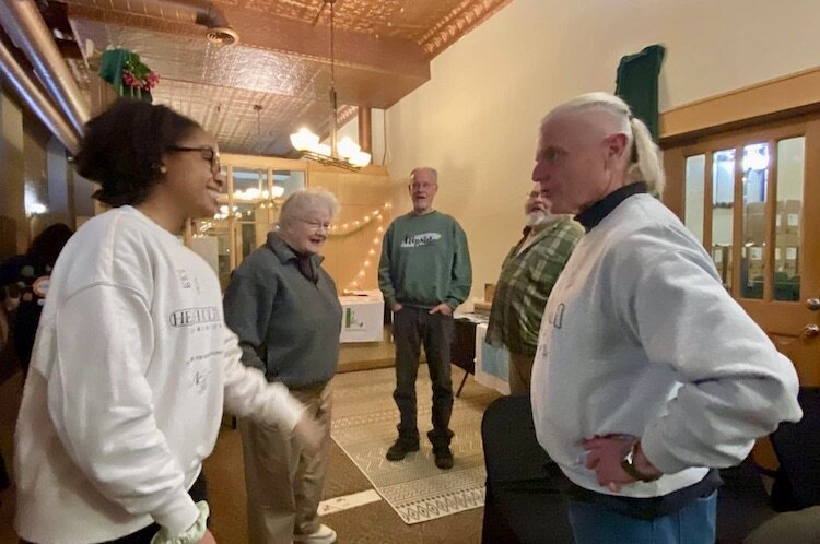 Several people gathered for an IPS-sponsored talk on the unique history of a downtown business corner.