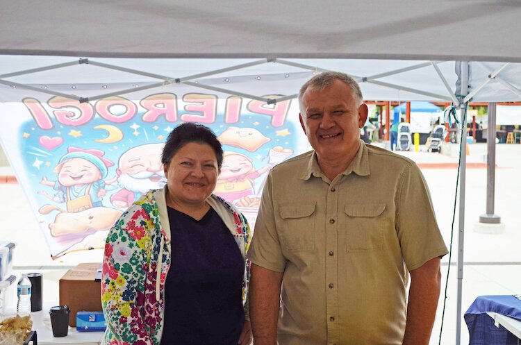 The couple works together to help customers at the Kalamazoo Farmers Market.