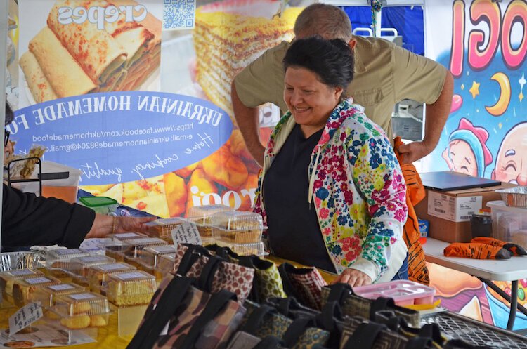 The couple works together to help customers at the Kalamazoo Farmers Market.