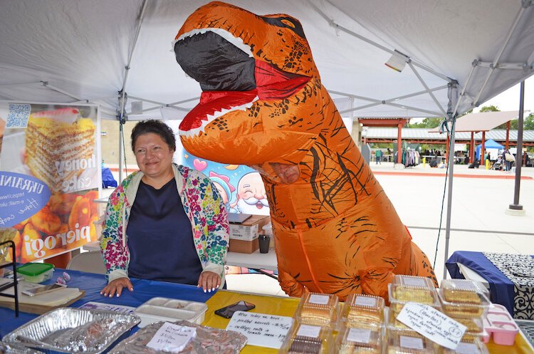 Severyn typically dons a blow-up costume of some sort. At this market, it was a T-Rex, which was a hit.