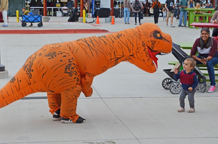 Severyn typically dons a blow-up costume of some sort. At this market, it was a T-Rex, which was a hit.