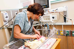 Robin Pierucci, MD examines baby