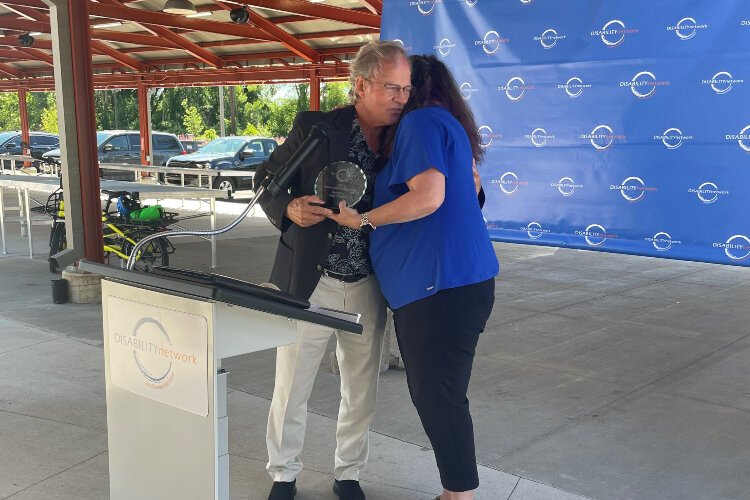 Joel Cooper and Mindy Kulasa hug during the the 2022 ADA Celebration.