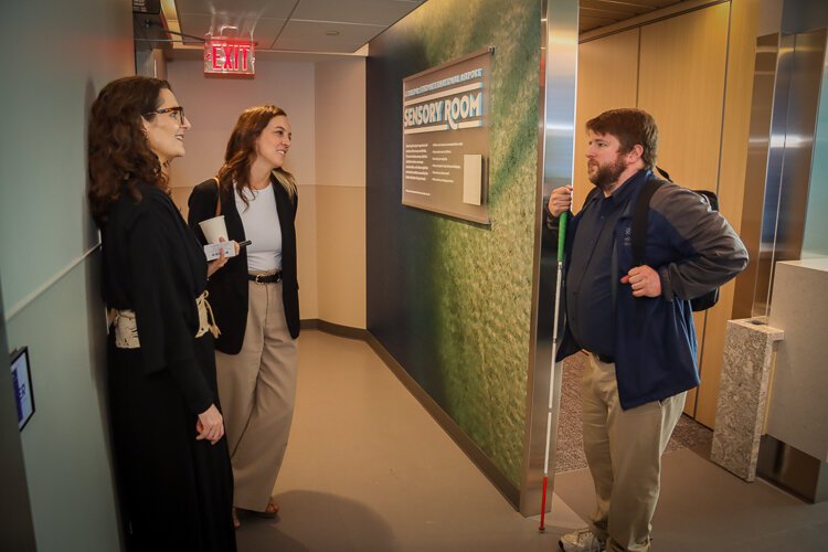 Lisa Adams, director of Citizen HKS, and Nicole Chapman, senior designer with HKS, converse with Jon Cauchi, an inclusion consultant with DAKC.