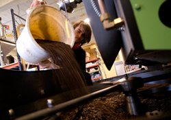 Waterstreet Roaster Warren Taylor pours coffee beans into the roaster / Photos by Erik Holladay