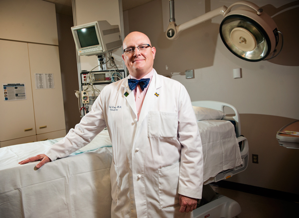 Paul Lange, MD, medical director, Borgess Critical Care Services stands with one of the InTouch Critical Care Beds from Stryker.