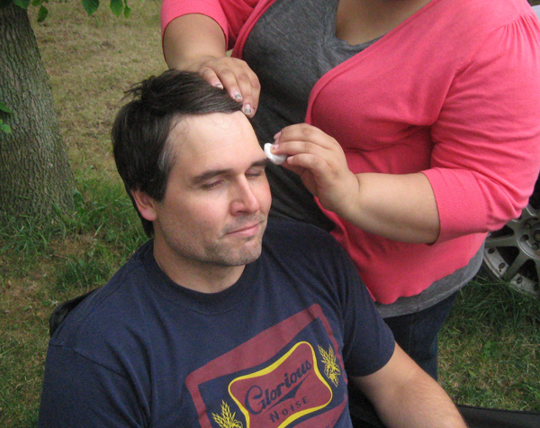 Leading man John Kasdorf has makeup applied by makeup artist Diana DeLarosa.