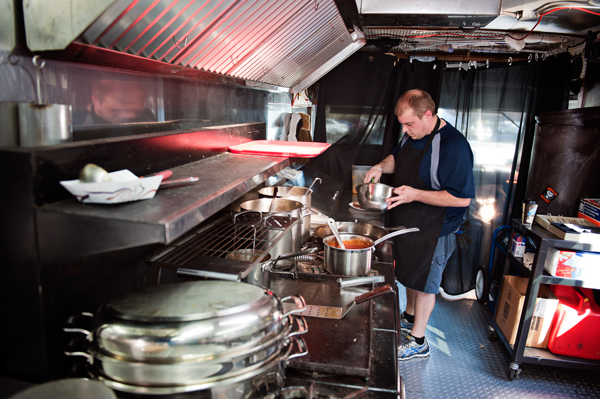 Gorilla Gourmet’s Noel Corwin prepares a BLAT at the Kalamazoo Farmers Market. 