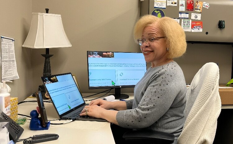 Karen Wynne works on her laptop at her desk.  