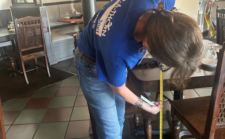 Disability Network Southwest Michigan’s Kelly Linton, an ADA specialist and systems advocate working with Wheel the World, takes measurements.