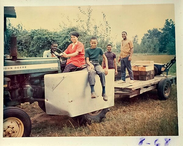 From left, worker Carl Jackson, Grace Mitchell (on tractor), Craig Mitchell, and workers Charlie Brooks and Stevie Bryant during harvest in 1968.