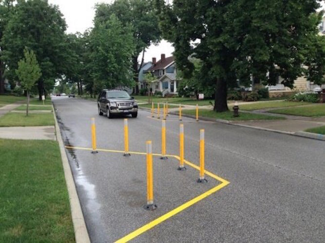 Chicanes are physical roadway barriers that include marked off areas that extend from the curb. They use flexible vertical posts that require motorists to slow down to navigate around them.