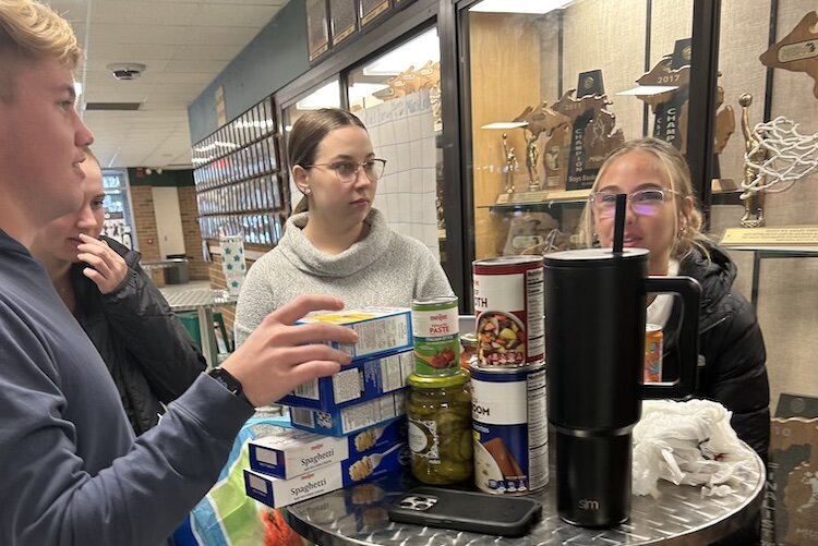 Student Council Leaders counting food and coins